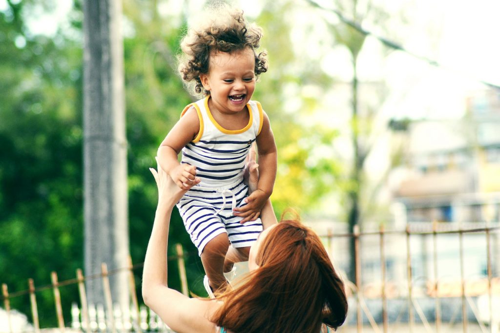 Smiling baby with mother.